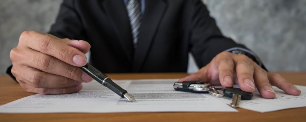 A security company owner manually reviewing security vetting documents