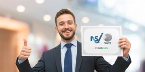 A man wearing a suit showcasing GuardPass's new achievement