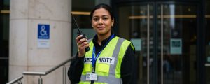 a female security officer holding a walkie talkie